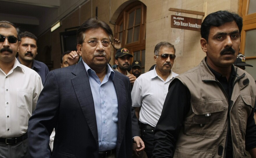 Surrounded by guards, Musharraf arrives at court in Karachi on March 29, 2013. His case is moving slowly through the legal system.