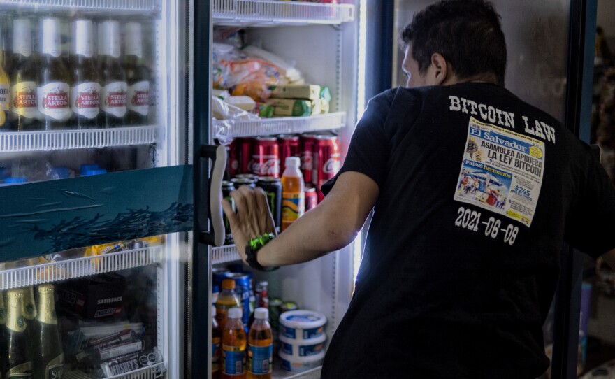 Santos Antonio Franco Valle, 23, wears a shirt commemorating the day the news came out about bitcoin becoming a legal tender of his country, El Salvador. He runs a convenience store in El Zonte.