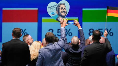 AfD supporters celebrate with a sign featuring top candidate Ulrich Siegmund after the first results of the Saxony-Anhalt state election at the party's election night gathering in Magdeburg, Germany, Sunday, Sept. 6, 2026.