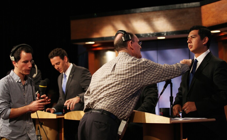 The KPBS crew prepares the candidates for a live televised debate at KPBS. 