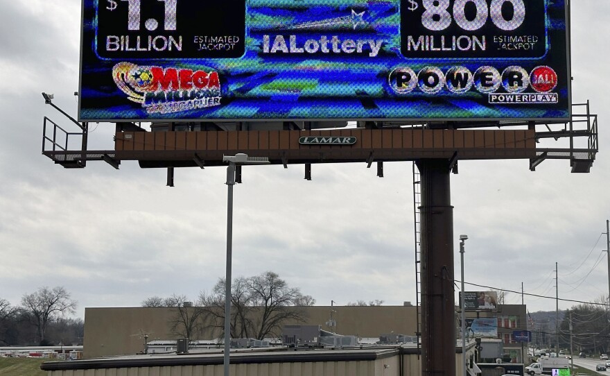 An electronic billboard advertises the Mega Millions and Powerball jackpots, Monday, March 25, 2024, in in Des Moines, Iowa, that when combined amount to nearly $2 billion.