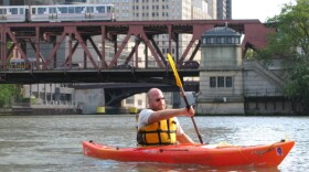 Josh Ellis, water resource project manager for the Metropolitan Planning Council of Chicago, a regional planning nonprofit, kayaks on the Chicago River. He paddles at the fork in the river where the south and north branches meet and once flowed east toward Lake  Michigan. Now, the river flows south toward the Mississippi, after the reversal of the Chicago River in the 1880s and 1890s.