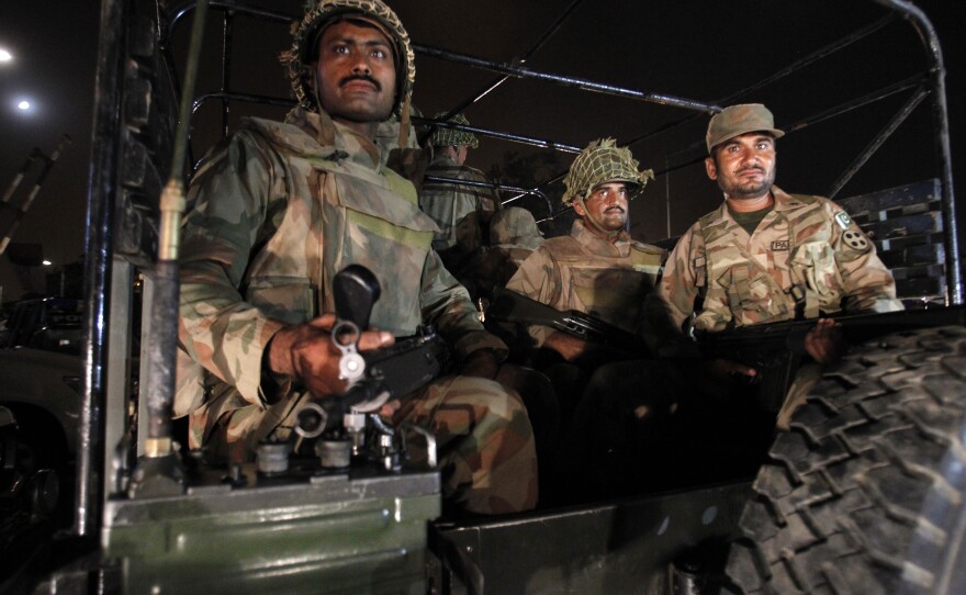 Pakistan army troops arrive at Karachi airport following an attack on June 8 by the Pakistani Taliban. More than 30 people were killed, and the military has now launched an offensive against the Taliban.