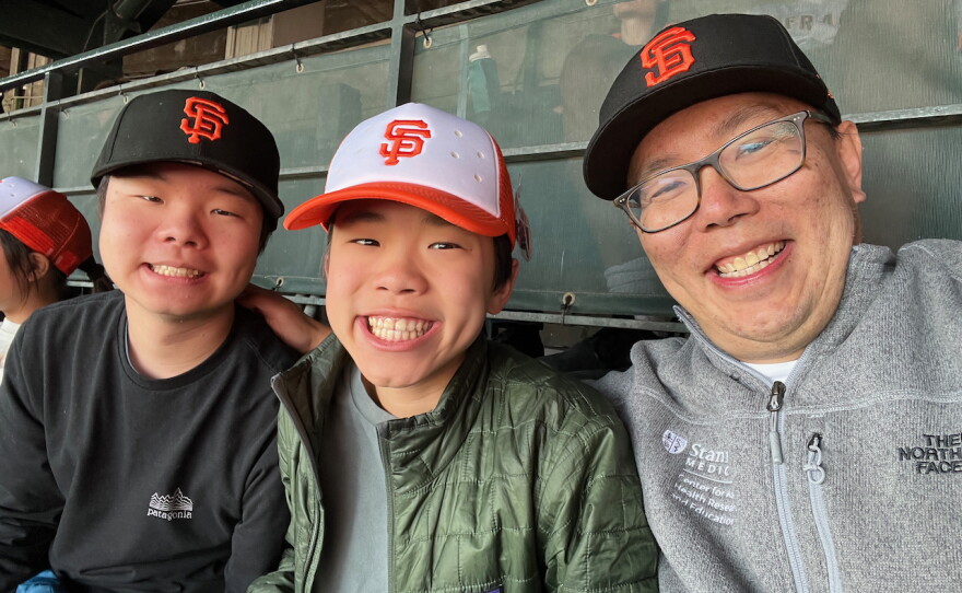 Dr. Bryant Lin with his sons at a San Francisco Giants baseball game in spring 2025. He says he loved going to Giants games with his sons before getting diagnosed. "Fortunately, we have been able to go again as a family in 2025 and 2026," he says.