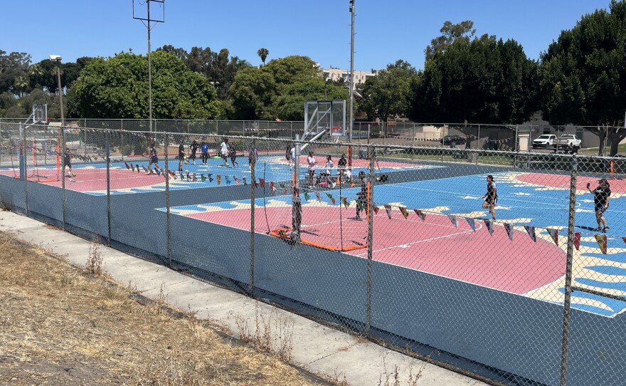 Youth soccer players play pickup games at Colina Del Sol Park's basketball courts, July 10, 2025.