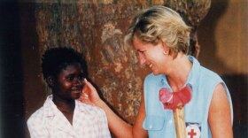 Diana, Princess of Wales talking with a young girl while visiting Angola. 