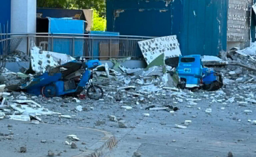 This shows vehicles damaged by debris after powerful earthquake in the Mindanao region, Philippines Monday, June 8, 2026.