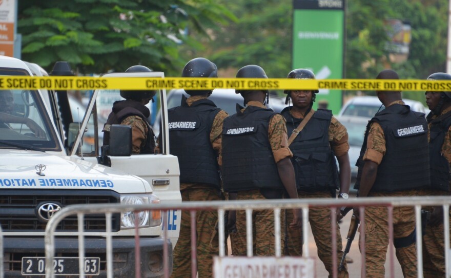 Burkinabe police gather in Burkina Faso's capital city, Ouagadougou, on Monday after an assault by gunmen killed 18 people.