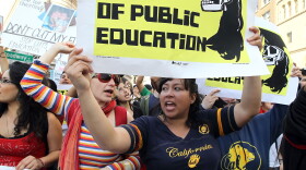 Demonstrators carry signs as they march to Oakland City Hall during a national day of action against school funding cuts and tuition increases March 4, 2010 in Oakland, California. 