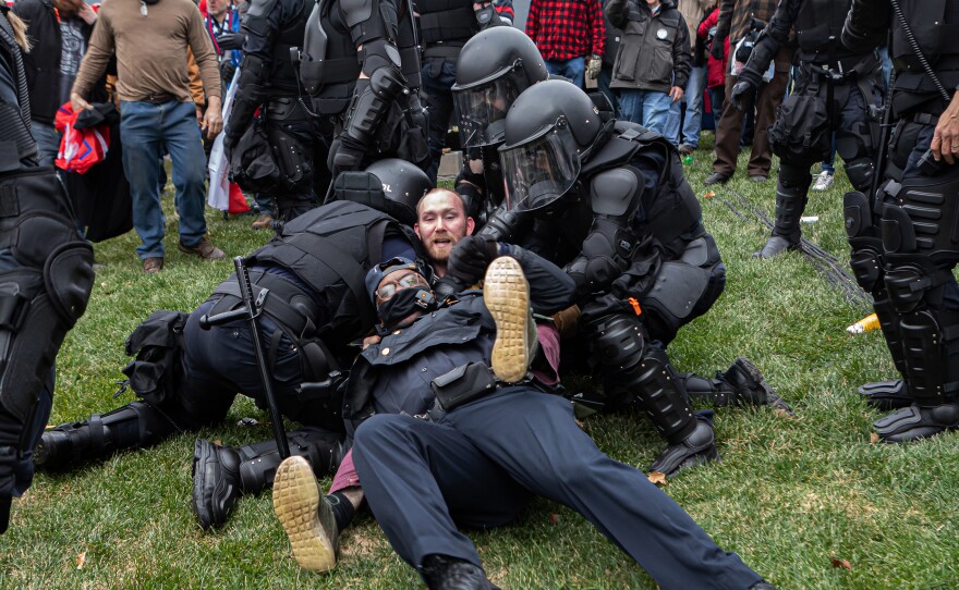 A Pro-Trump protester resists arrest on Wednesday. Hundreds breached the U.S. Capitol Building but there were few arrests in relation to the scope of the unrest as of Wednesday night