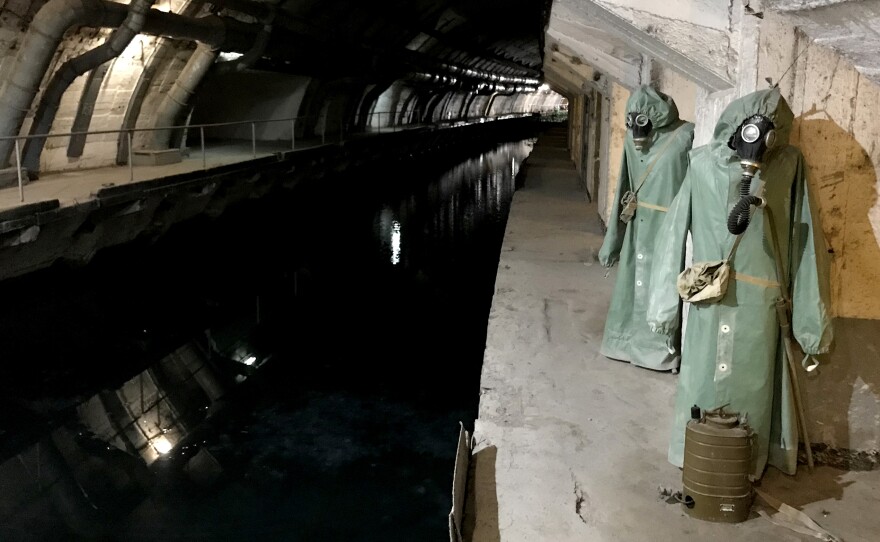 Hazmat suits hang next to the canal that leads from Balaklava Bay to the heart of the underground base.