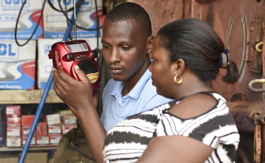 People listen to the radio as the results of the presidential elections are announced in Kireka, Uganda, in February. Many rural Ugandans don't have Internet access, and the radio is a central source of news — and platform for citizens' opinions.