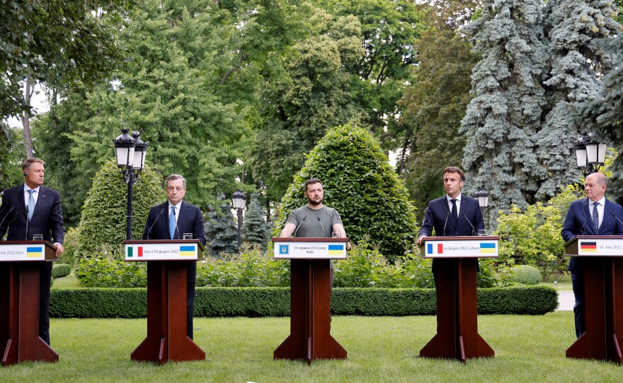 From left, Romanian President Klaus Iohannis, Prime Minister of Italy Mario Draghi, Ukrainian President Volodymyr Zelenskyy, France's President Emmanuel Macron and German Chancellor Olaf Scholz attend a press conference in Kyiv on Thursday. The French, German, Italian and Romanian leaders vowed to back Kyiv's bid to become an official candidate to join the European Union.