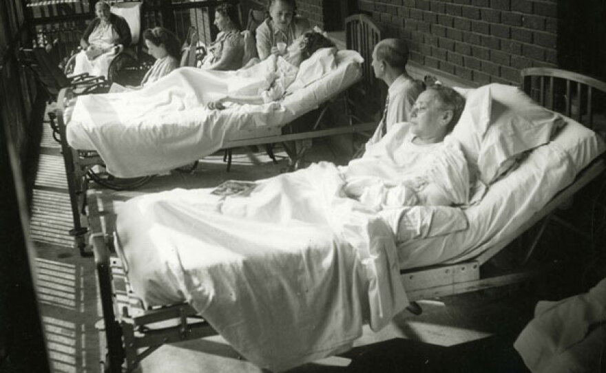 A group of female patients on a sun porch at the hospital.