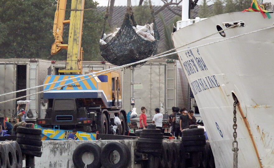 A 3,000-ton cargo ship, at Thajeen Port in Samut Sakhon, Thailand, 15 days after it set sail from Benjina, Indonesia. The company that owns the ship said it is not involved with the fishermen. "We only carry the shipment and we are hired, in general, by clients," said owner Panya Luangsomboon. "We're separated from the fishing boats."