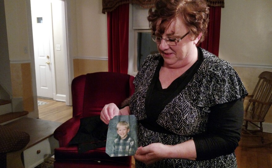 Toni Hoy, at her home in Rantoul, Ill., holds a childhood photo of her son, Daniel, who is now 24. In a last-ditch effort to get Daniel treatment for his severe mental illness in 2007, the Hoys surrendered parental custody to the state. "When I think of him, that's the picture I see in my mind. Just this adorable, blue-eyed, blond little sweetie," Hoy says.