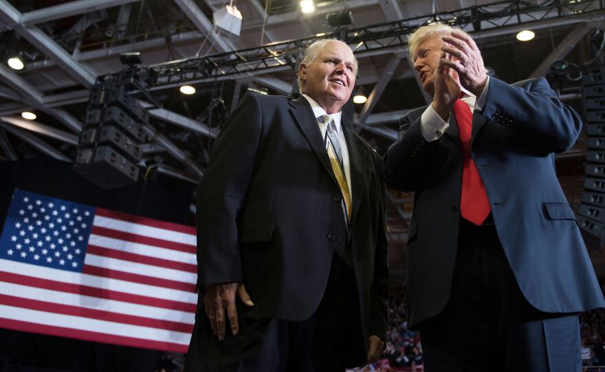 Talk show host Rush Limbaugh, pictured with then-President Donald Trump at a rally in November 2018, died on Wednesday.