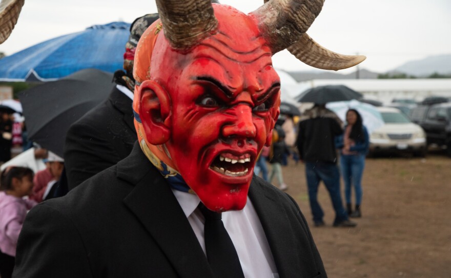 A dancer with the Oaxacan dance group Los Diablos poses for a portrait in the rain at an event in Valley Center, California on September 21, 2025,