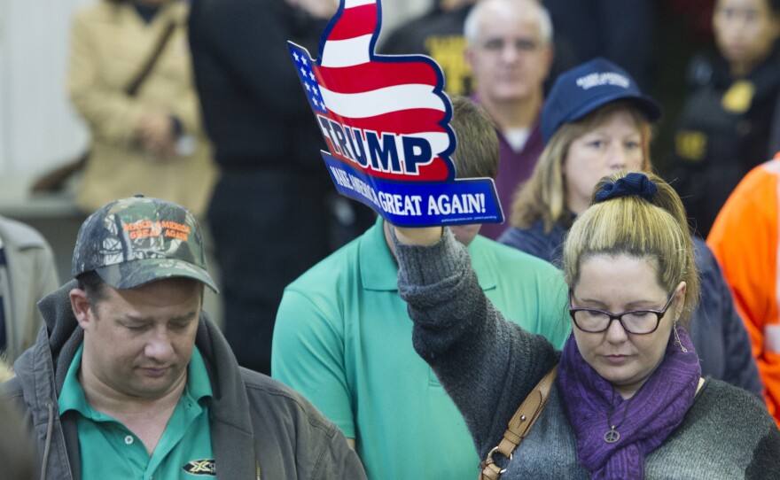 Attendees at a Donald Trump rally in Manassas, Va., take part in a prayer and moment of silence after the San Bernadino, Calif., shootings.