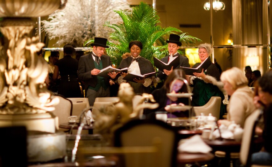 Carolers sing during Christmas tea at the Drake Hotel in Chicago. In some fancy hotels, Christmas tea has become a refined respite for harried holiday shoppers. But the tradition's roots are much rowdier: efforts to fight public drunkenness.