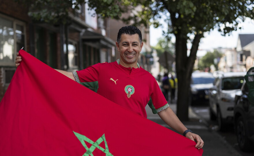 Mustapha Chliah, a Morocco supporter, poses for a portrait holding a Moroccan flag before the Brazil vs. Morocco FIFA World Cup 2026 group-stage match in Paterson, N.J., on June 13.