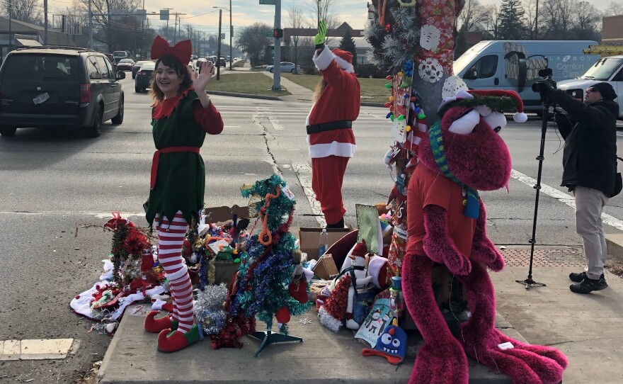 Toledo's Christmas Weed (upper left corner), which is now so heavily decorated that you can barely see it, provided a little holiday cheer at a busy intersection Wednesday.