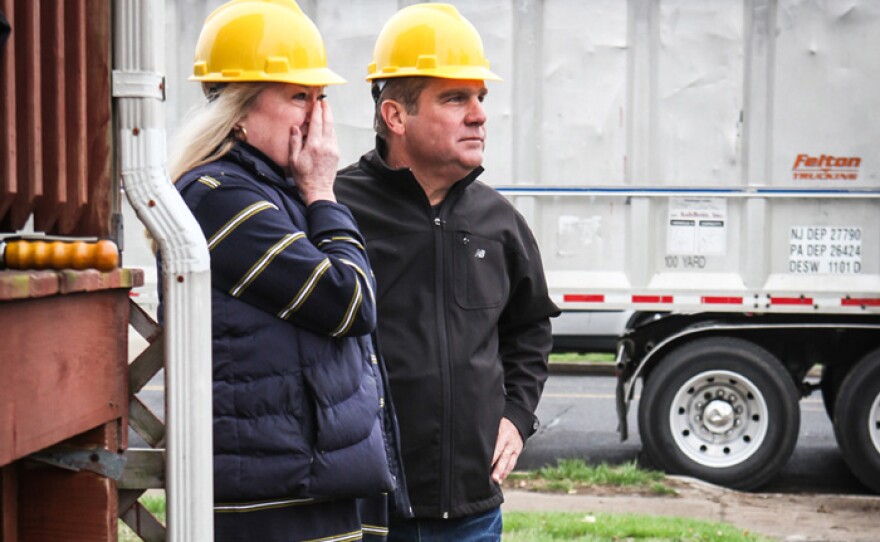 Rita Gurry and plumbing and heating expert Richard Trethewey watch as Rita's Manasquan, New Jersey, home — damaged beyond repair — is demolished.