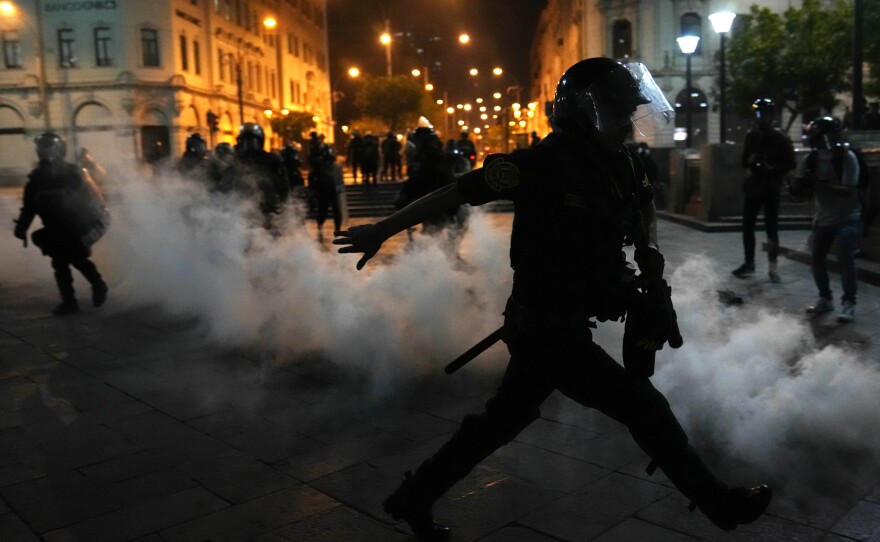 Tear gas is thrown back at police trying to break up supporters of ousted President Pedro Castillo at Plaza San Martin in Lima, on Dec. 11.