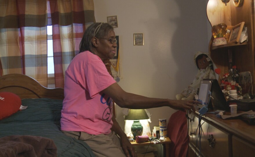 Annie Ford of Ruleville, Mississippi, uses a tablet that monitors her blood sugar levels as part of a new program from the University of Mississippi Center for Telehealth.