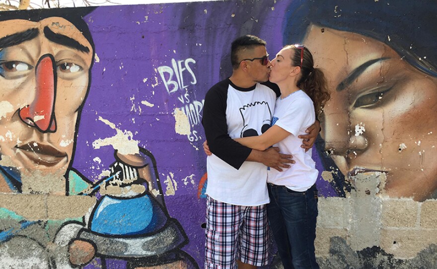 Marcos and his wife Elizabeth kissing.