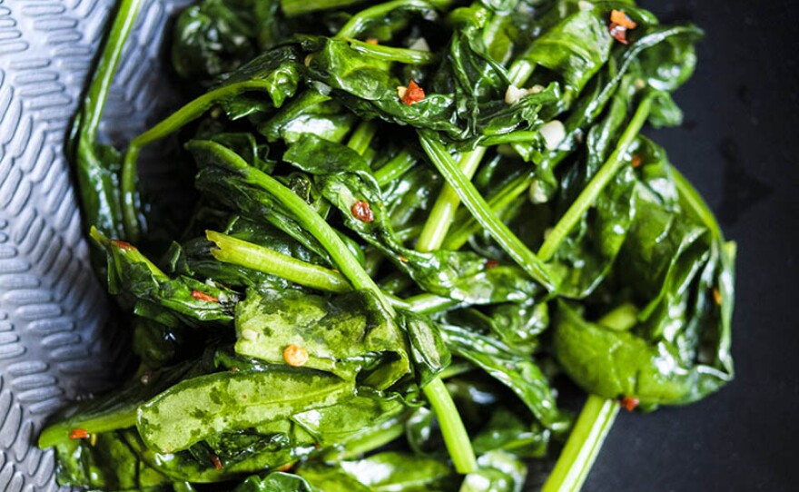 In this episode, host Chris Kimball travels to Chiang Mai, Thailand, where he learns how to transform a simple bowl of broth and rice into an explosion of flavors and textures. Back in the kitchen, Milk Street cook Matthew Card shows how to make Thai stir-fried spinach with just a few simple ingredients (pictured).