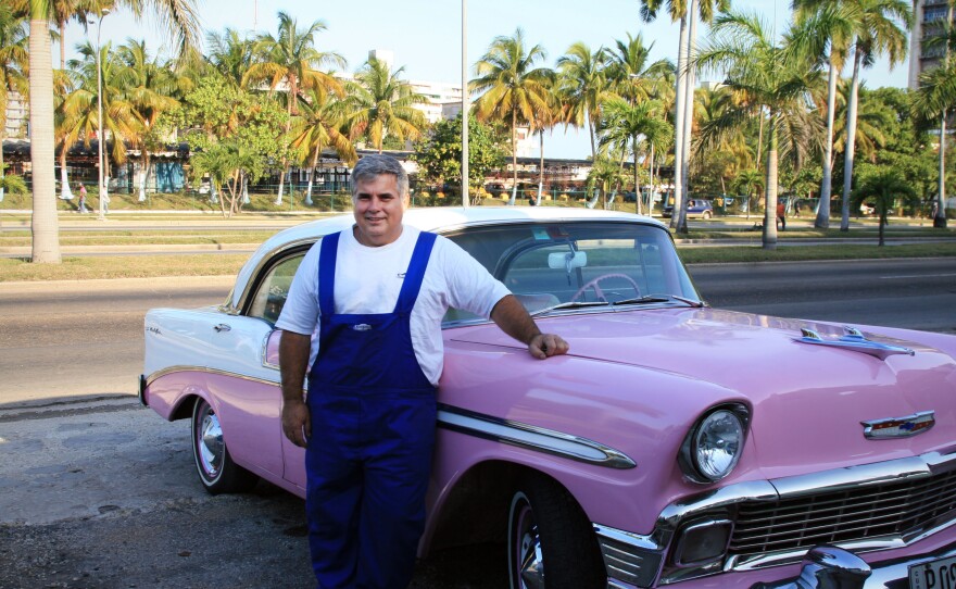 Julio Alvarez standing in front of Lola, a 1956 Chevy Bel Air.