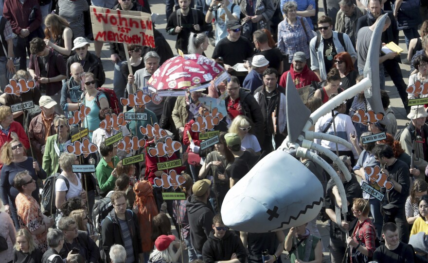 Protesters in Berlin carry a giant "rent shark" at a march against rent increases on Saturday.