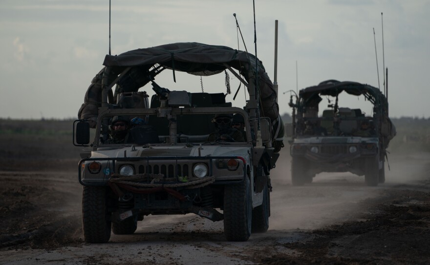 Israeli Jeeps leave Gaza, as seen from Israel's southern border with the Gaza Strip, Thursday.
