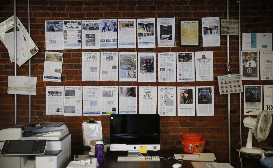 A wall in <em>The Daily Tar Heel</em>'s newsroom is lined with memorable headlines.
