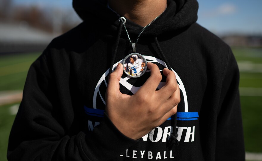 Jalen Beard holds a pendant he wears in remembrance of his friend.