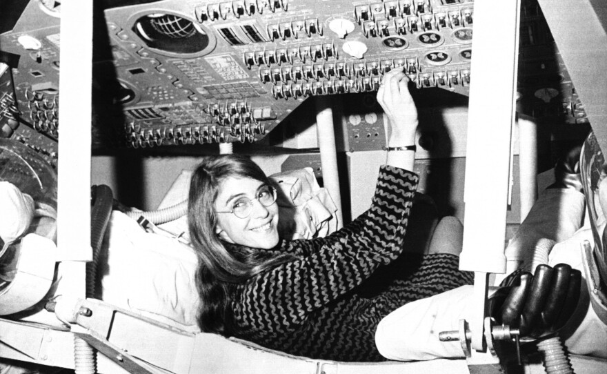Margaret Hamilton sits in mock-up of Apollo the command module on display  at MIT in 1969.