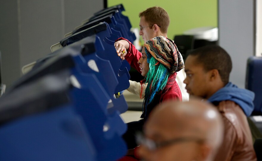 Voters cast their ballot during early voting at a polling station at Truman College in Chicago, Illinois.