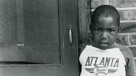 Brandon Thrasher stands in front of East Lake apartment. Atlanta, Ga. Circa 1990. 
