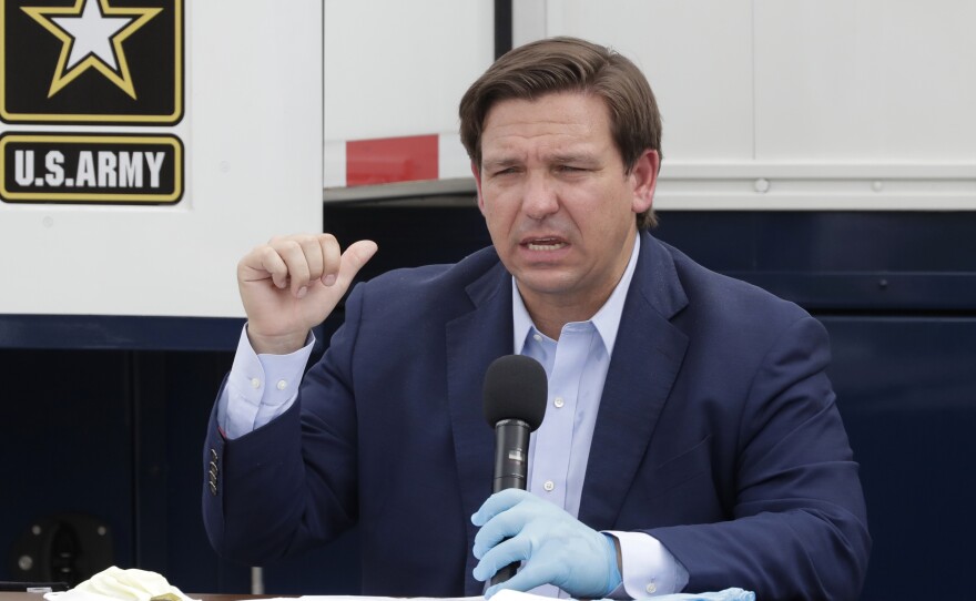Florida Gov. Ron DeSantis speaks during a news conference in front of a U.S. Army Corps of Engineers mobile command center at the Miami Beach Convention Center, last week. DeSantis says he wants to ramp up testing at the state's long-term care facilities.
