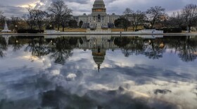 Clouds are reflected in the U.S. Capitol reflecting pool at daybreak in Washington as Day Three of the government shutdown continues, Monday, Jan. 22, 2018.