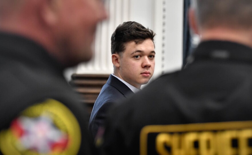 Kyle Rittenhouse, center, looks back as Kenosha County Sheriff's deputies enter the courtroom to escort him out of the room during a break in the trial at the Kenosha County Courthouse in Kenosha, Wis., on Friday, Nov. 5.
