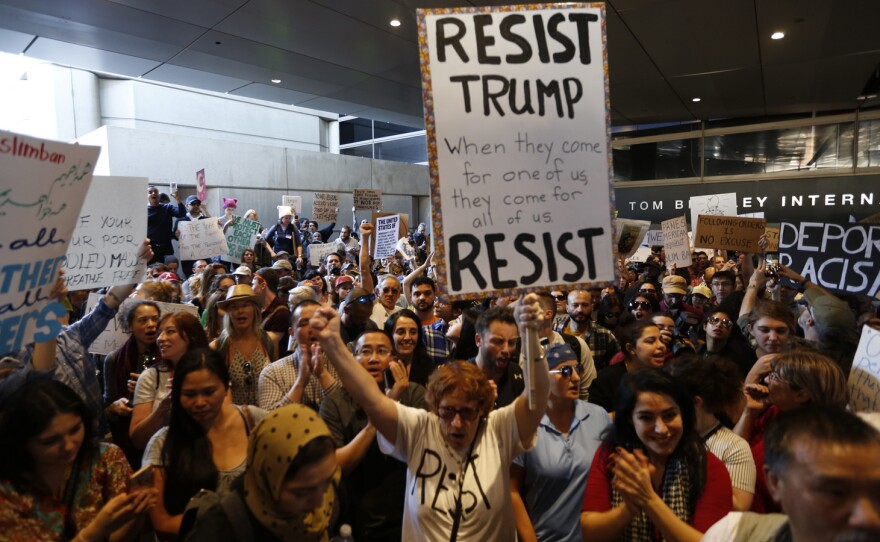 Hundreds of people protest President Trump's travel ban at LAX airport Sunday in Los Angeles.