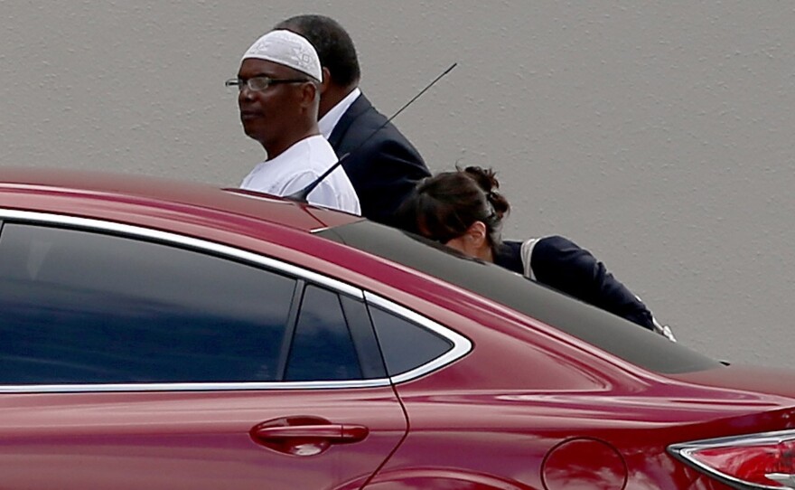 William Potts, an American accused of hijacking a Florida-bound flight and diverting it to Cuba in 1984, arrives at FBI headquarters after arriving Wednesday. Potts will make an initial court appearance today.