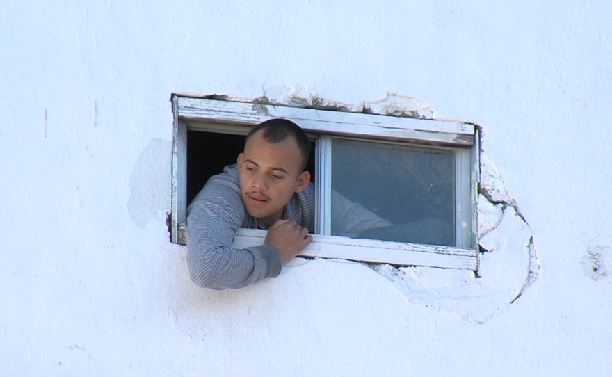 A patient hangs from a window at the Tijuana rehabilitation center El Mezón, March 30, 2015.