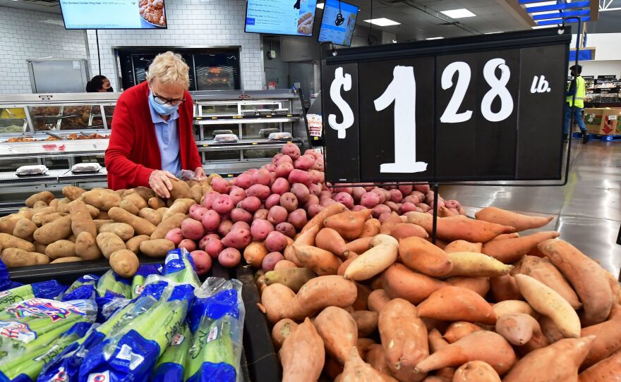 A shopper selects a potato at a supermarket in Rosemead, Calif., on April 21. Inflation remains a top concern for the Federal Reserve.