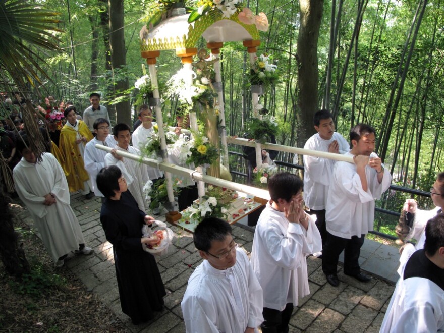 China's Catholics have traditionally been divided into two churches. One, the "open" or government-sanctioned church, and the "underground," or Vatican-sanctioned church. Here, clergy from the government-sanctioned church hold a procession to the Sheshan basilica on the outskirts of Shanghai.