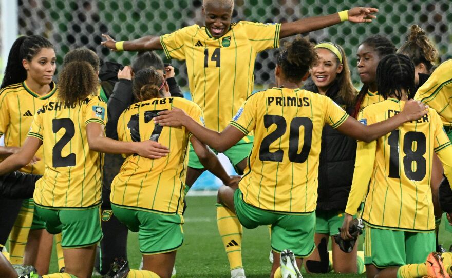 Jamaica celebrates qualifying for the round of 16 after tying Brazil in Melbourne on Wednesday.