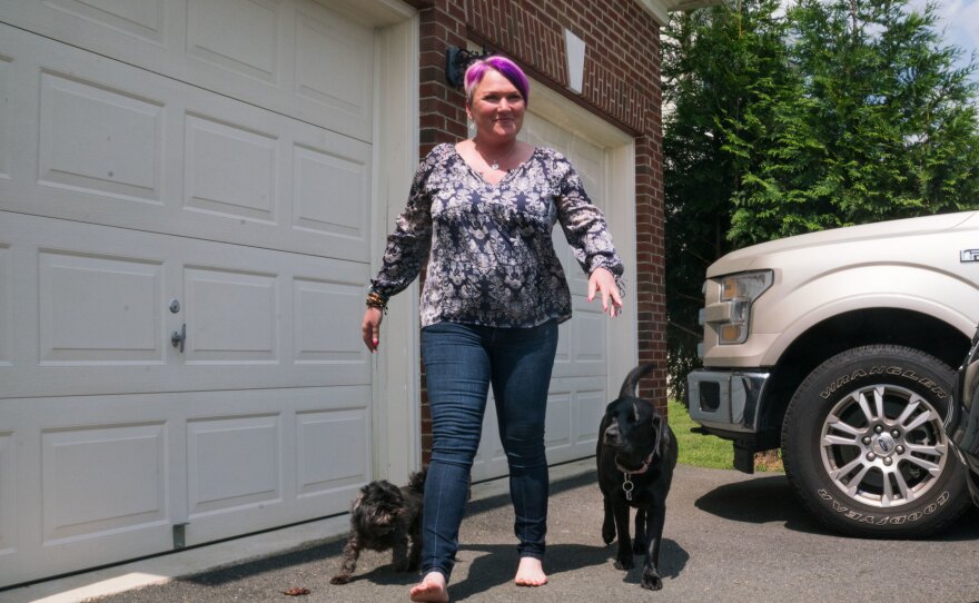 Blade, Michel and Lizzy wander outside. In 2016, Michel applied for a service dog from the organization Semper K9 in northern Virginia and instantly knew Lizzy was the dog for her.
