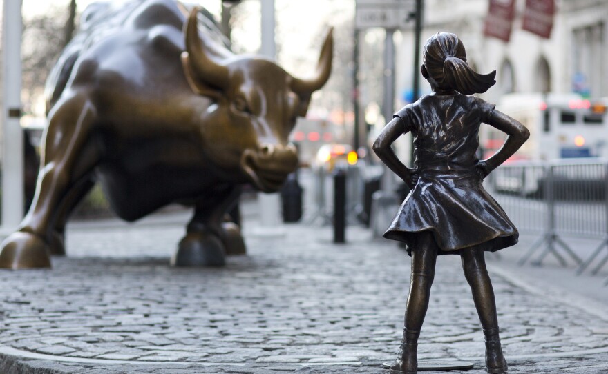 The Charging Bull and Fearless Girl square off in New York City's financial district. Arturo Di Modica, the bull's sculptor, says the girl staring it down has changed the meaning of his work in an unwelcome way.
